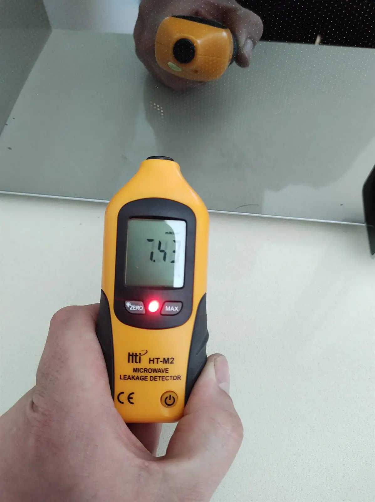 Microwave leakage detector in use during an appliance safety check